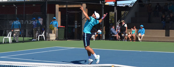 Focus Tennis Academy Player tossing tennis ball into air