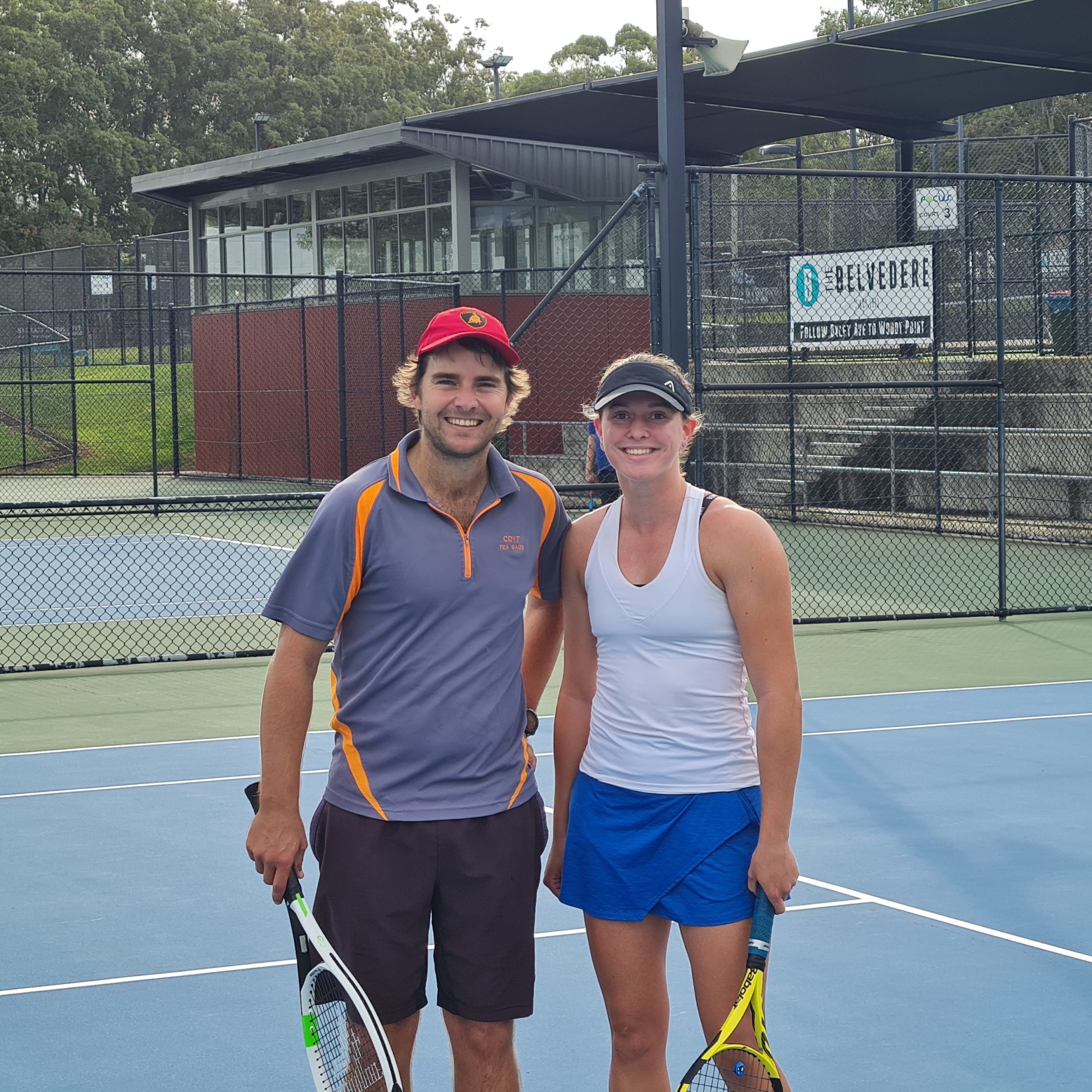Focus Tennis Academy adult tennis player stnading on tennis court with coach